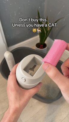 Loading a waste bag roll into the self-bagging cat litter scoop